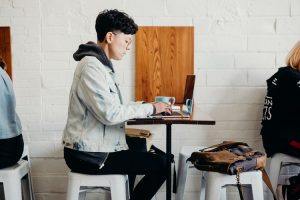 Man in cafe with working on laptop