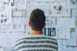 Person looking at the wall full with papers