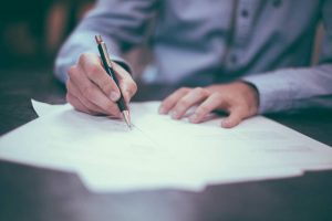 A man signing paperwork
