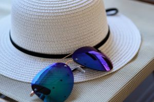 A sun hat and a pair of sunglasses.
