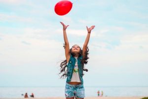 little girl playing with a ball