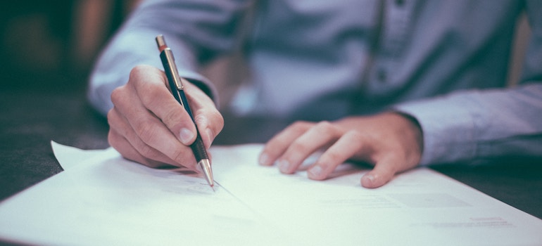 a man signing a document- pick the right insurance