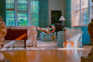 a woman sitting in the livingroom thinking where to move to after divorce
