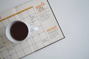 Pantry moving guide written in a notebook with a coffee cup on the top