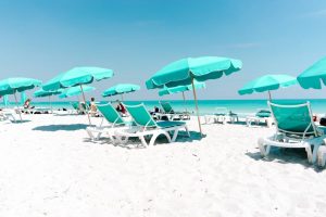 white and green loungers on the beach