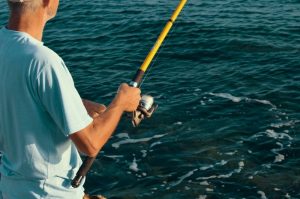 Man fishing on annual Fishing Rodeo.
