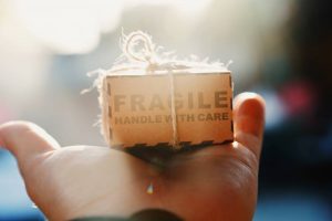 person holding a small box