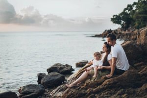 family sitting on the rocks