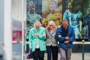 two women and one man walking