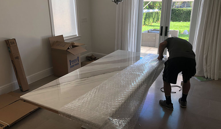 one of the Hialeah movers packing a mattress