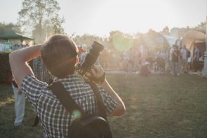 A kid photographing at the festival
