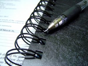 a pen on a notebook for making schedules