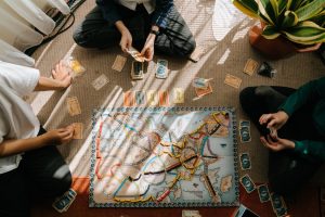 family playing board game and realizing that it's a perfect way to spend time with kids during winter break