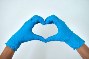 Blue gloves forming a heart shape