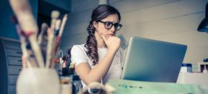 A woman looking at the computer