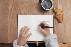 a woman writing a list
