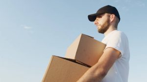 Professional mover carrying boxes