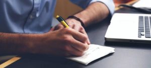 man writing a list
