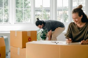 Picture of two people packing for the move