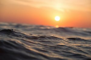 A shining Sun over a body of water