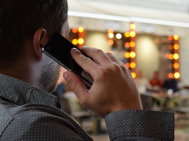 a man talking on the phone - choose a moving company when relocating to Pompano Beach