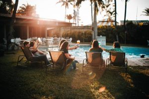 A group of people sit on garden chairs