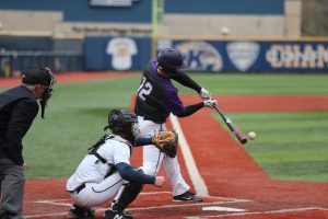 a man striking a ball in baseball