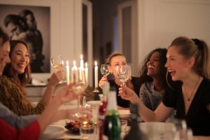 A group of females are seating around the table
