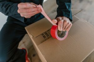 a man taping the box
