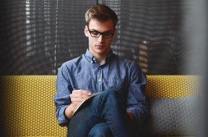 a man writing in his notebook