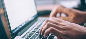man typing on a computer researching how to take advantage of different storage solutions