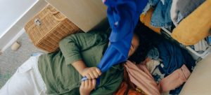 A girl lying covered with clothes