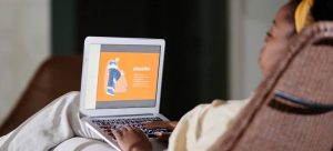a woman looking at the computer to find an affordable home in Miami