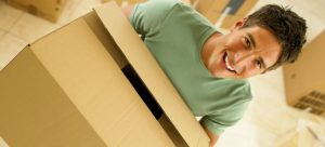 man smiling because he is moving in with a new roommate