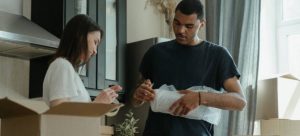 Two people packing things in their kitchen.