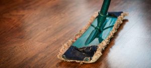 Wooden brown floor being cleaned