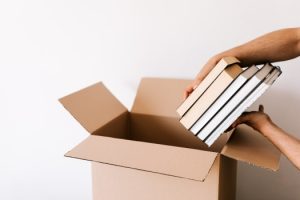 a person putting books in a box