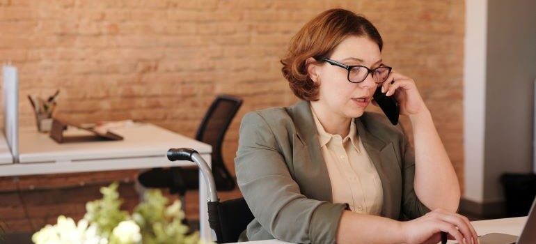 A woman talking on the phone with one of the best interstate moving companies Miami has to offer