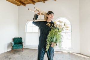A mover handling a plany and a stool