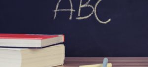 books in front of a blackboard