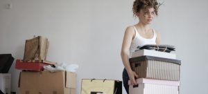 A girl carrying boxes