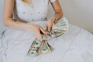 A woman holding dollar bills