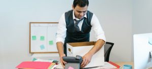 man packing office before moving business to Miami