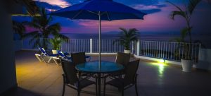 Round Metal Patio Near Railings at Night.