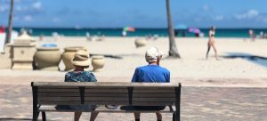 grandparents on the beach thinking about buying a condo in Miami