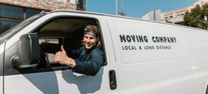 a mover in a moving truck trying to explain the cost of hiring Miami movers