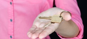 a landlord handing the keys to the owner after purchasing a second home in Fort Lauderdale