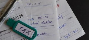 a few pieces of paper with taxes that need to be paid and a pen