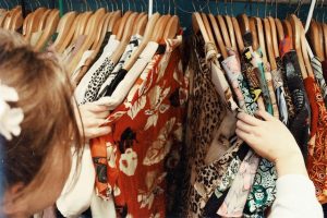 a woman going through her dresses