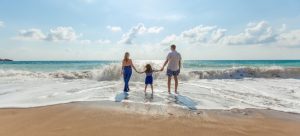 A family on the beach following the moving trends in Florida